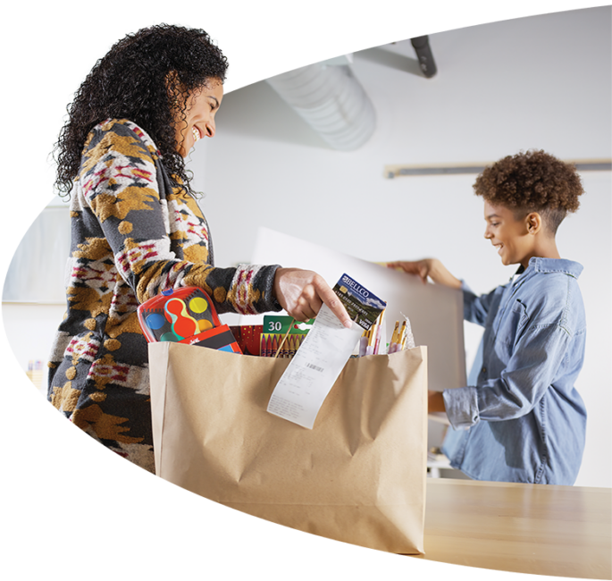 Image of a woman holding a Bellco debit card.