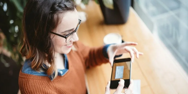 Person taking a picture of a check with their phone